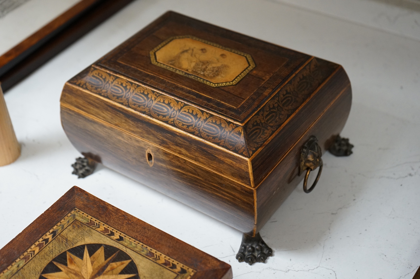 A Regency rosewood and pen work box with paw feet and two late 19th century German band work boxes, largest 25cm wide. Condition - fair/good